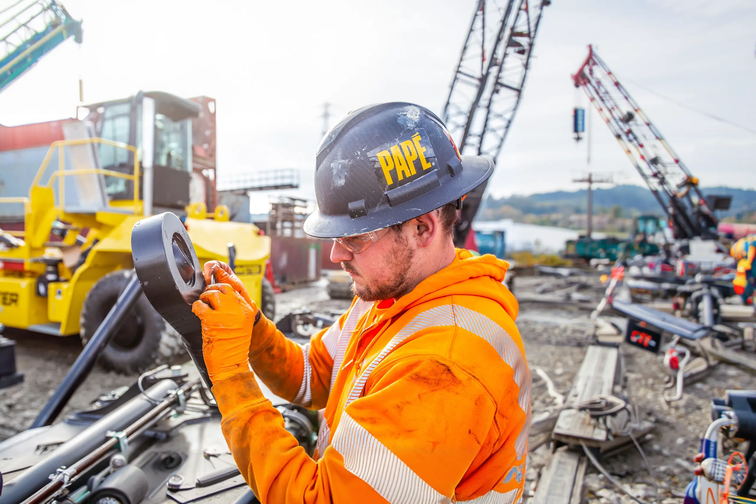 Papé worker inspecting crane hook onsite
