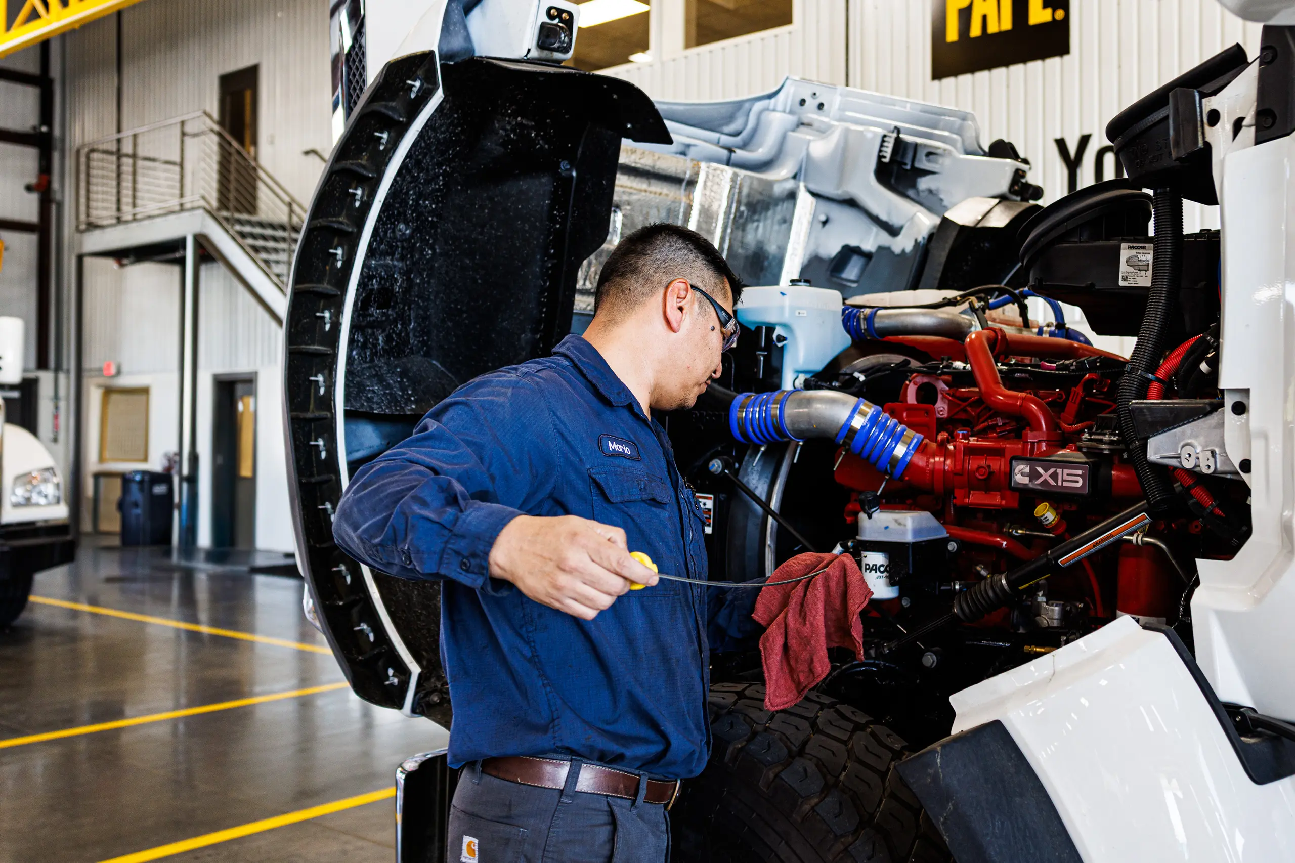 Technician checking Cummins X15 truck engine