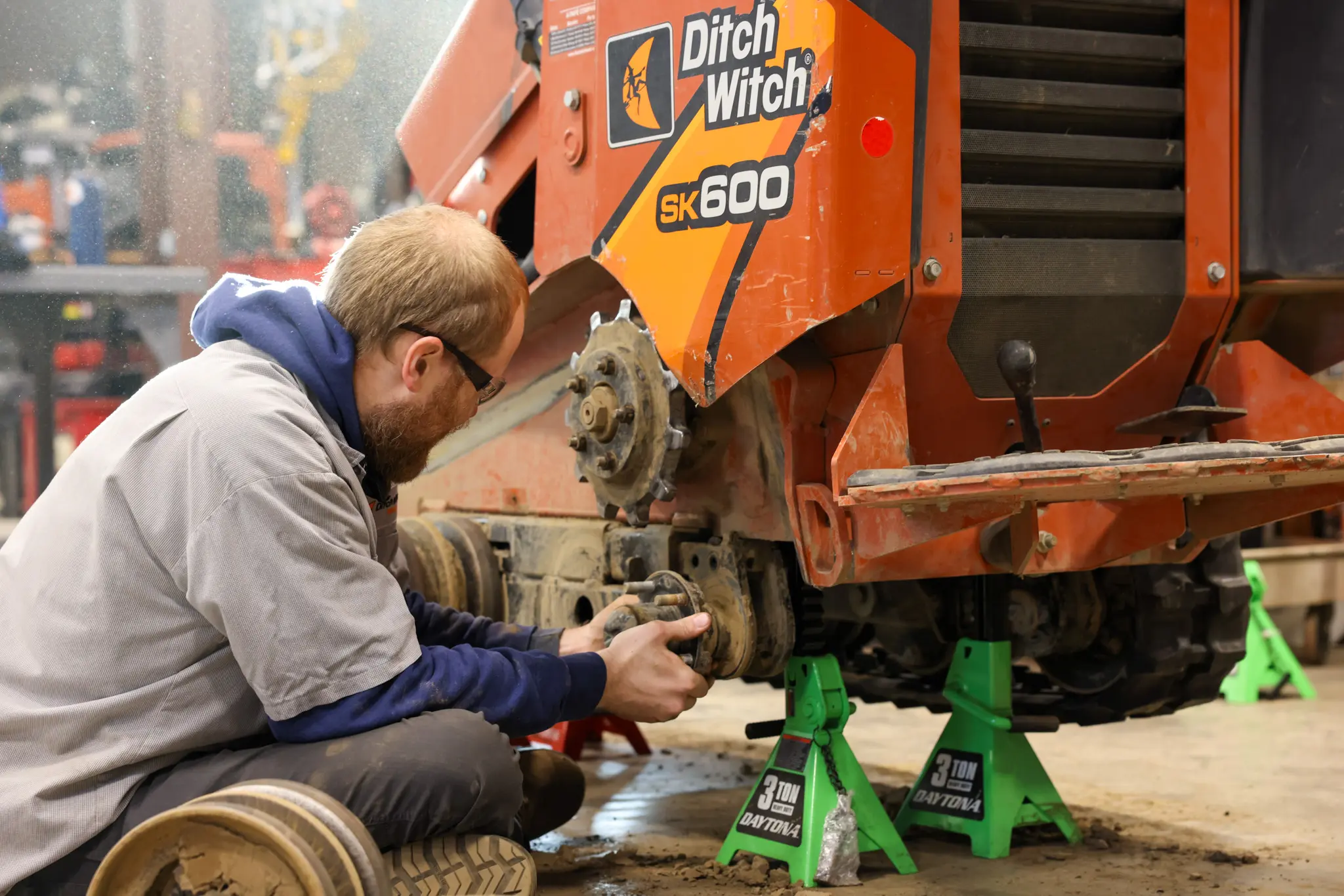 Technician repairing Ditch Witch track drive