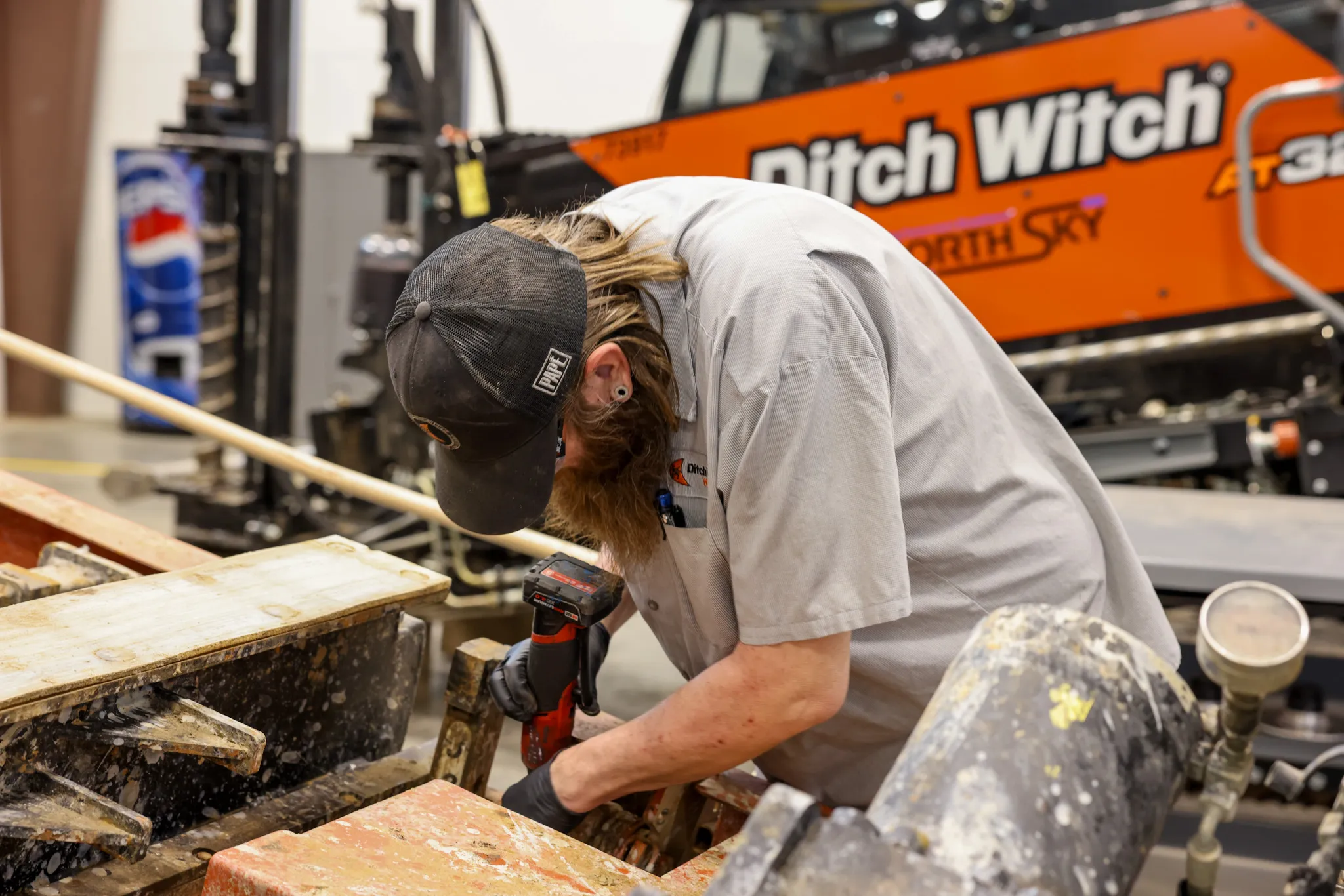 Ditch Witch West technician working on repair