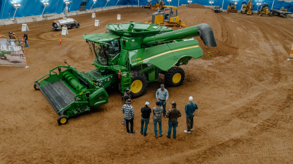 Group viewing John Deere combine at expo