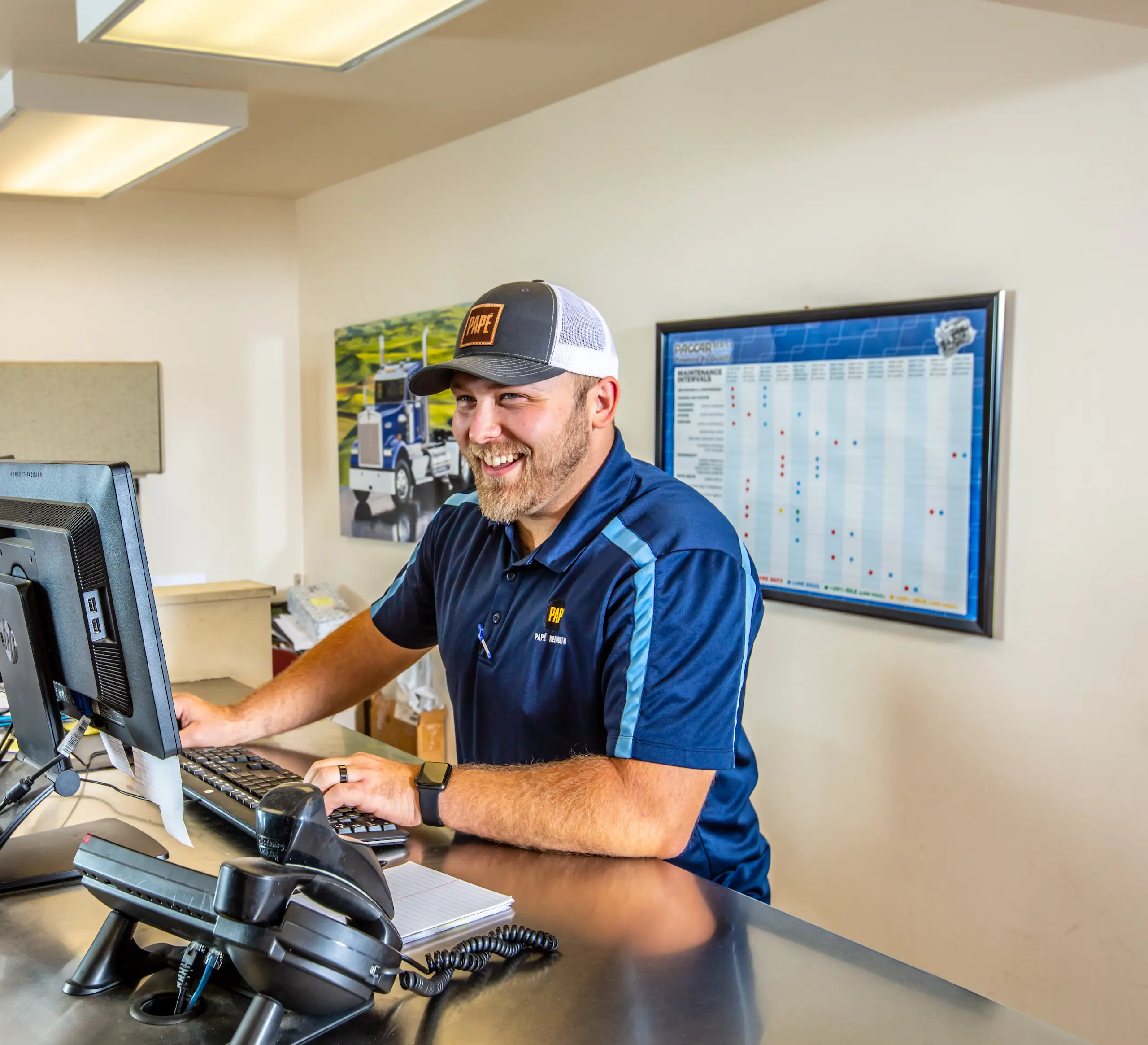 Papé Kenworth employee smiling at desk