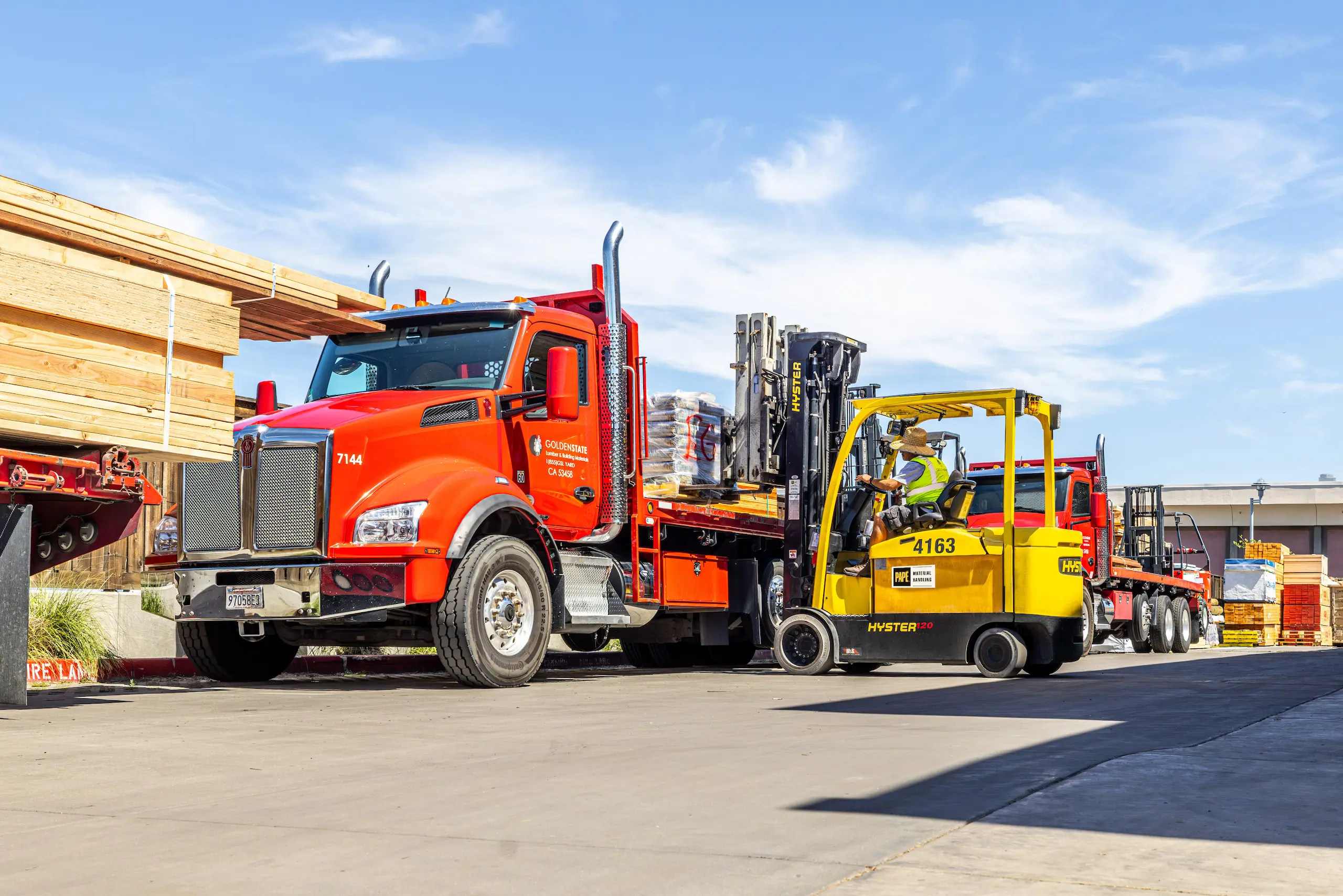 Forklift loading pallets onto flatbed truck