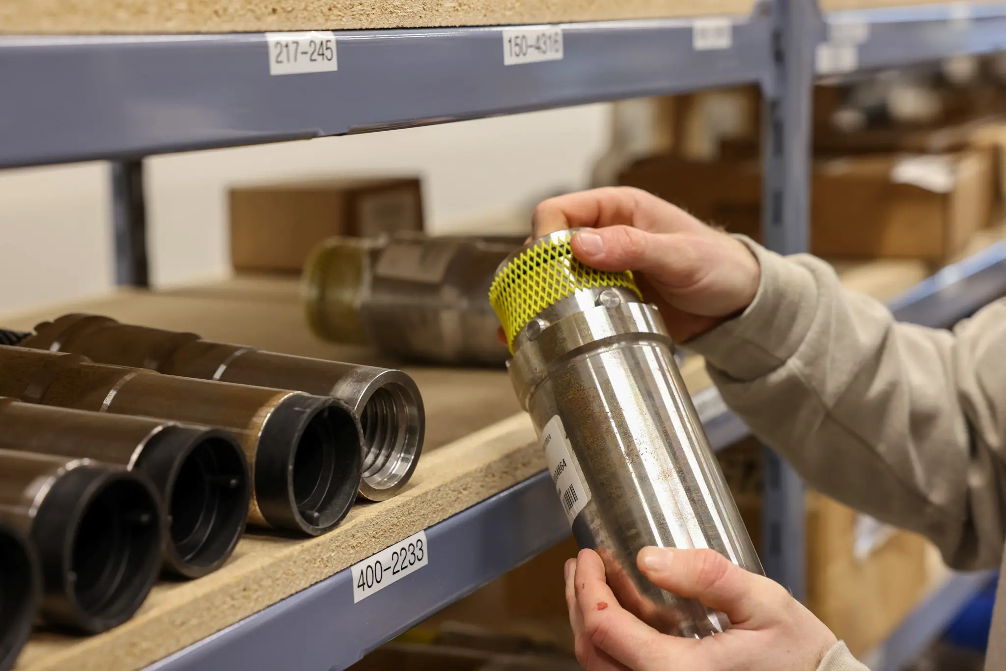 Hands holding metal filter part warehouse