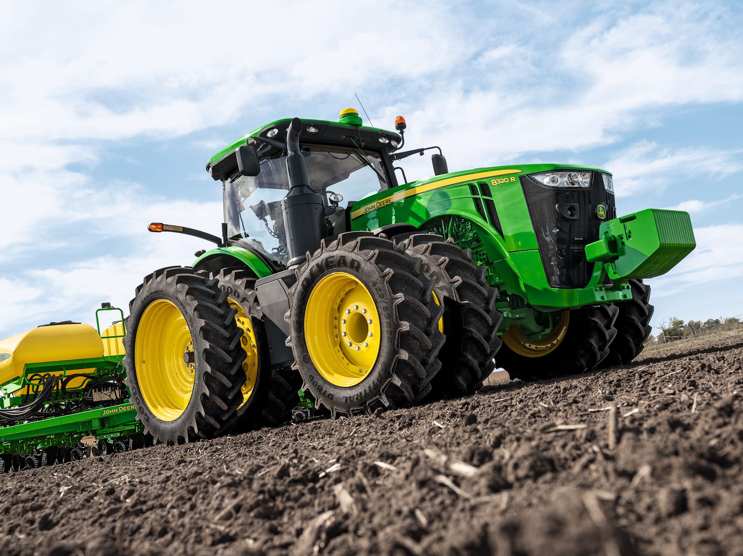 John Deere 8320R tractor tilling soil