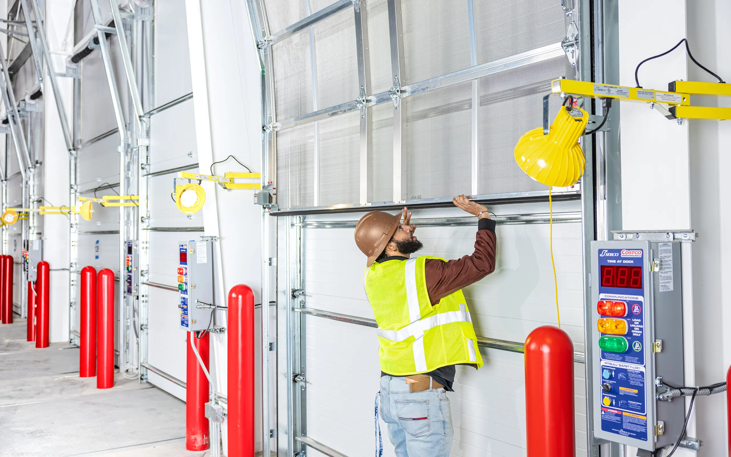 Worker inspecting warehouse loading dock door