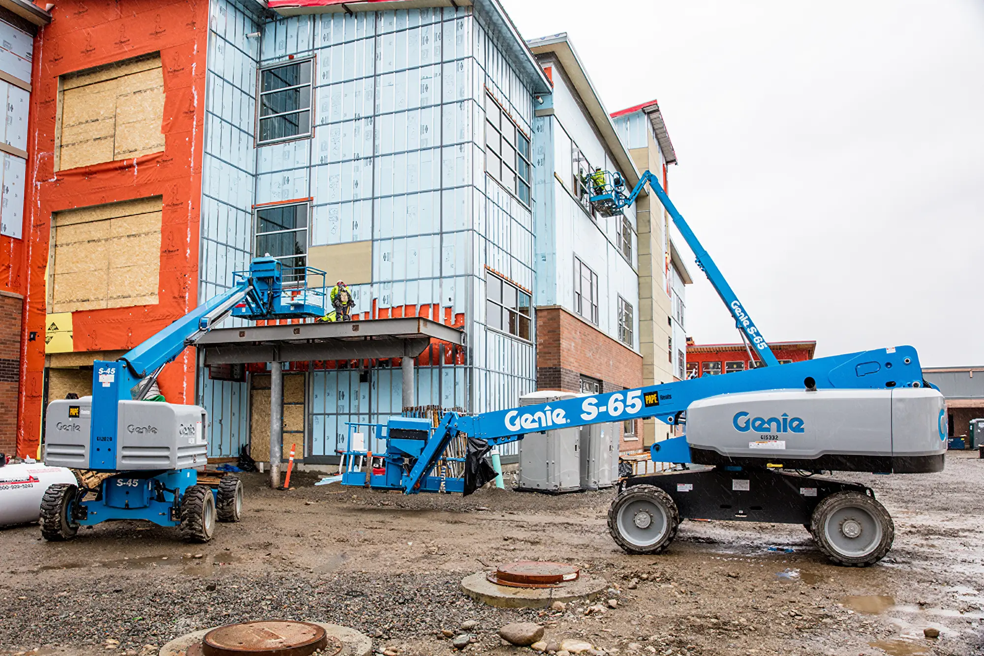 Genie boom lifts at construction site