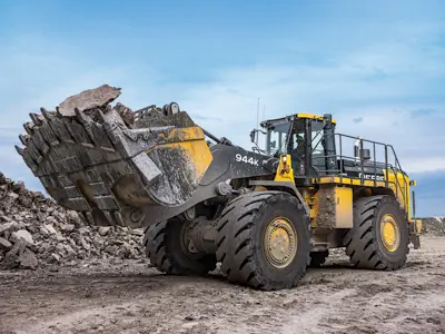 Wheel loader lifting bucket of rubble