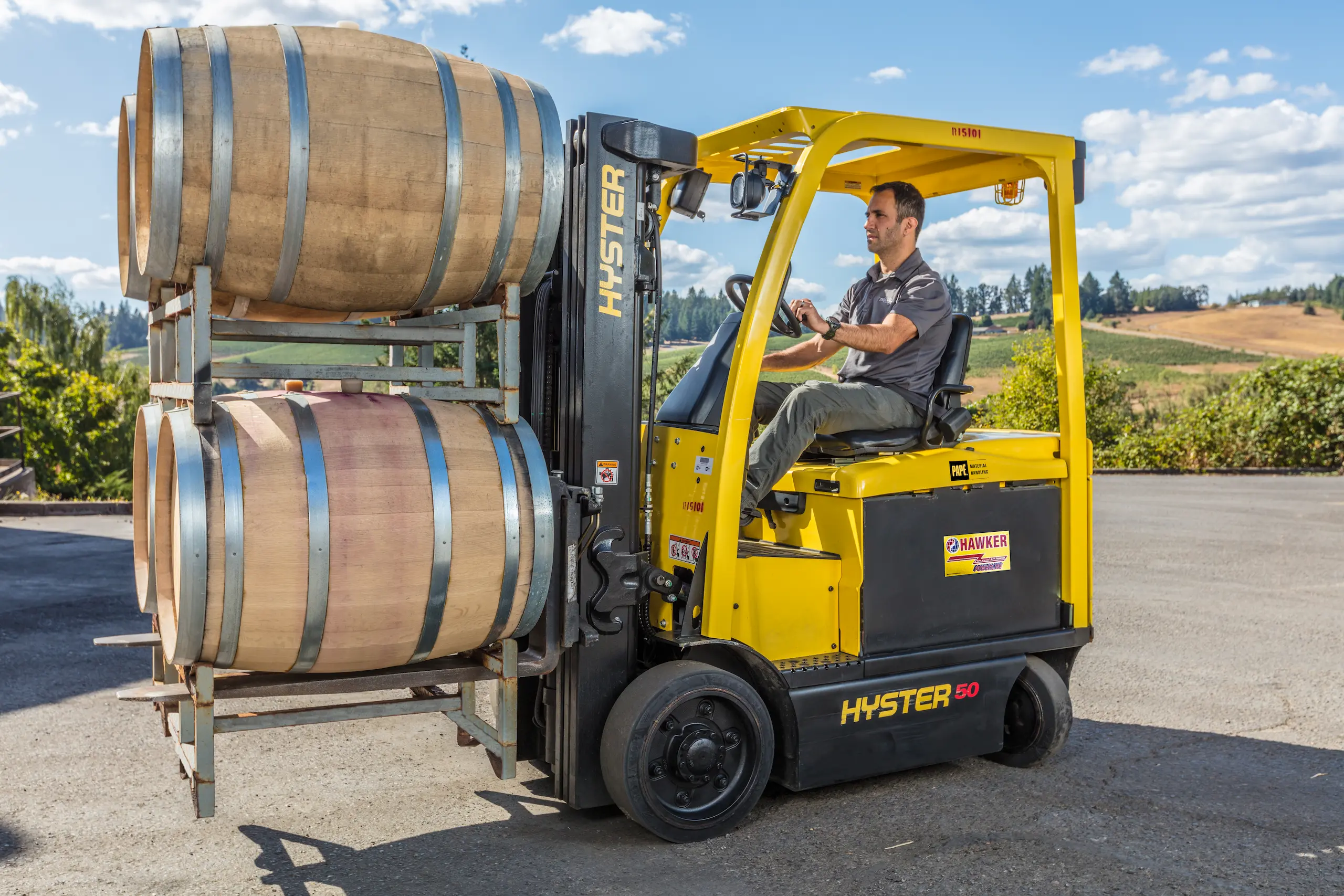 Forklift carrying wine barrels at vineyard