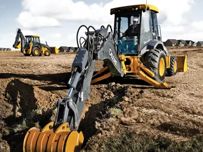Backhoe digging trench with grapple attachment