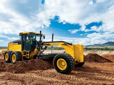 Yellow motor grader working on dirt