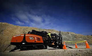 Ditch Witch drill rig on hillside