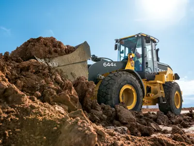 John Deere wheel loader scooping dirt