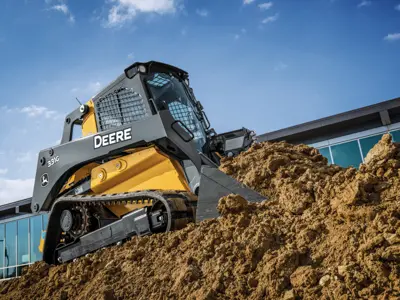 John Deere skid steer climbing dirt