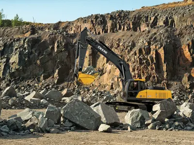 Excavator digging in rocky quarry pit