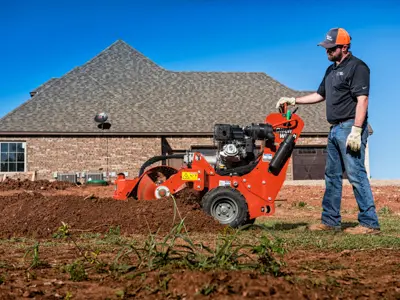 Man operating trencher near new home