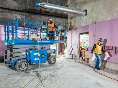 Worker on scissor lift indoor construction