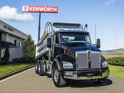 Black Kenworth dump truck at dealership