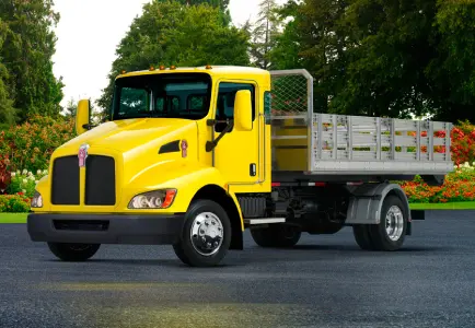 Yellow Kenworth flatbed truck outdoors
