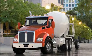 Orange concrete mixer truck on street