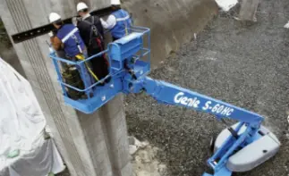 Workers on boom lift near wall
